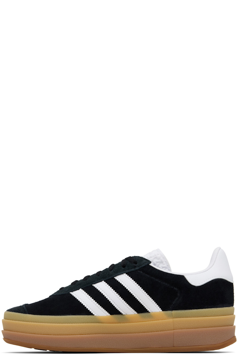 Low-top suede sneakers.

· Lace-up closure
· Logo printed at tongue
· Padded collar
· Signature serrated stripes at sides
· Logo printed at outer side
· Faux-leather and jersey lining
· Logo embossed at stacked rubber midsole
· Treaded rubber sole
· Platform: H1.75"

Supplier color: Core black/Cloud white/Cloud white