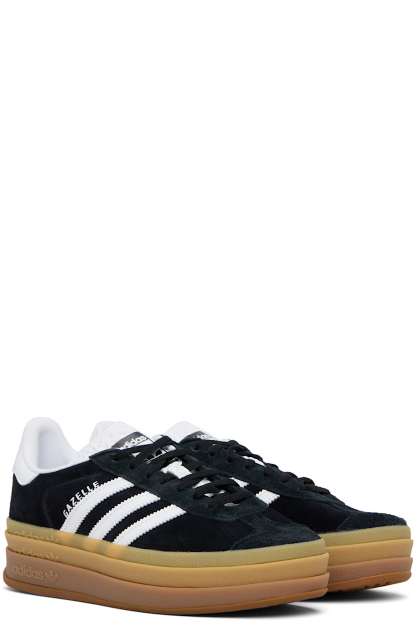 Low-top suede sneakers.

· Lace-up closure
· Logo printed at tongue
· Padded collar
· Signature serrated stripes at sides
· Logo printed at outer side
· Faux-leather and jersey lining
· Logo embossed at stacked rubber midsole
· Treaded rubber sole
· Platform: H1.75"

Supplier color: Core black/Cloud white/Cloud white