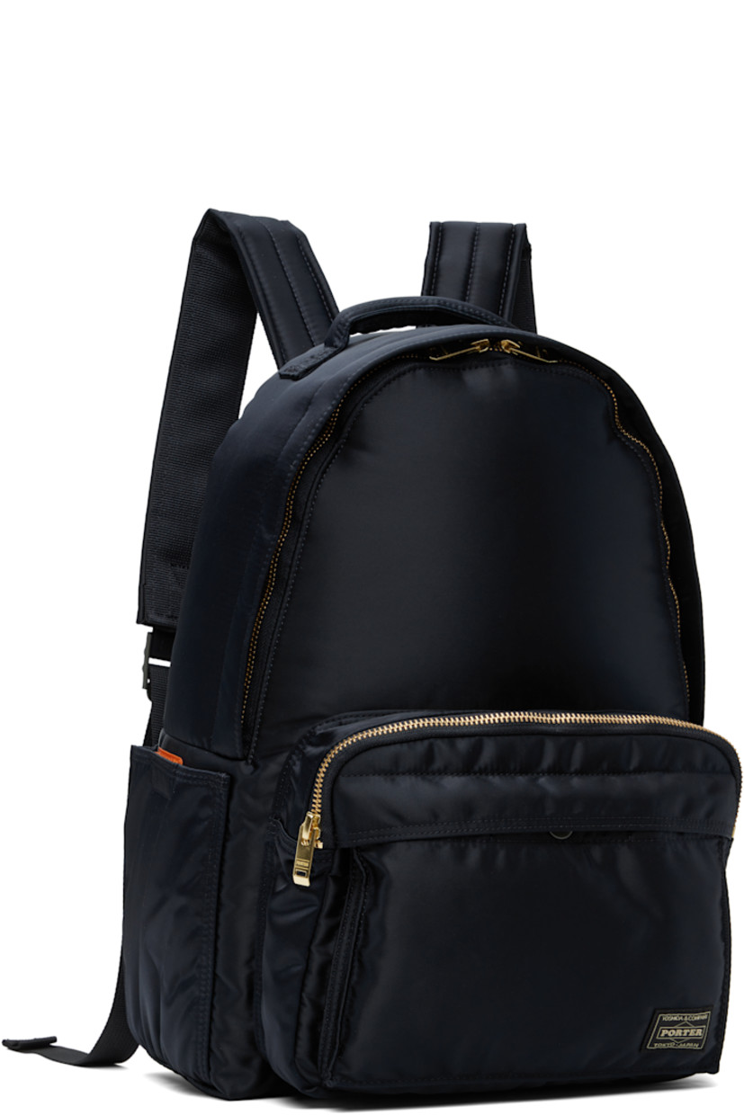 Nylon twill backpack in navy.

· Padded carry handle
· Adjustable padded shoulder straps
· Bellows pocket at zip compartment
· Logo patch at face
· Patch pocket at sides
· Padded back face
· Two-way zip closure
· Patch pocket at interior
· Taffeta lining
· Logo-engraved gold-tone hardware
· H15" x W11.5" x D5.25" / 12 L

Supplier color: Iron blue