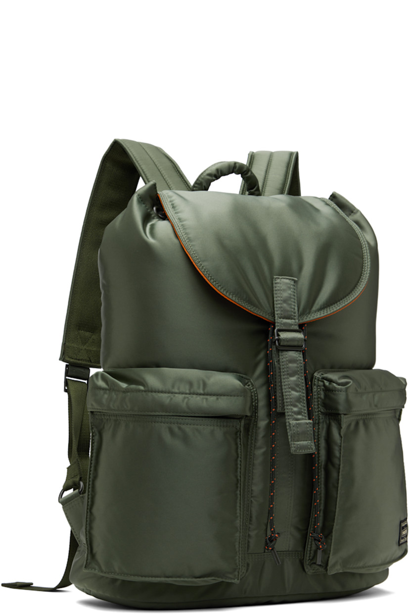 Nylon twill backpack in khaki.

· Padded carry handle
· Adjustable padded shoulder straps
· Zip compartments and logo patch at face
· Zip closure at padded back face
· Flap with press-stud fastening
· Cord-lock drawstring closure
· Patch pocket at interior
· Taffeta lining
· Logo-engraved gold-tone hardware
· H17" x W13" x D5" / 14 L

Supplier color: Sage green