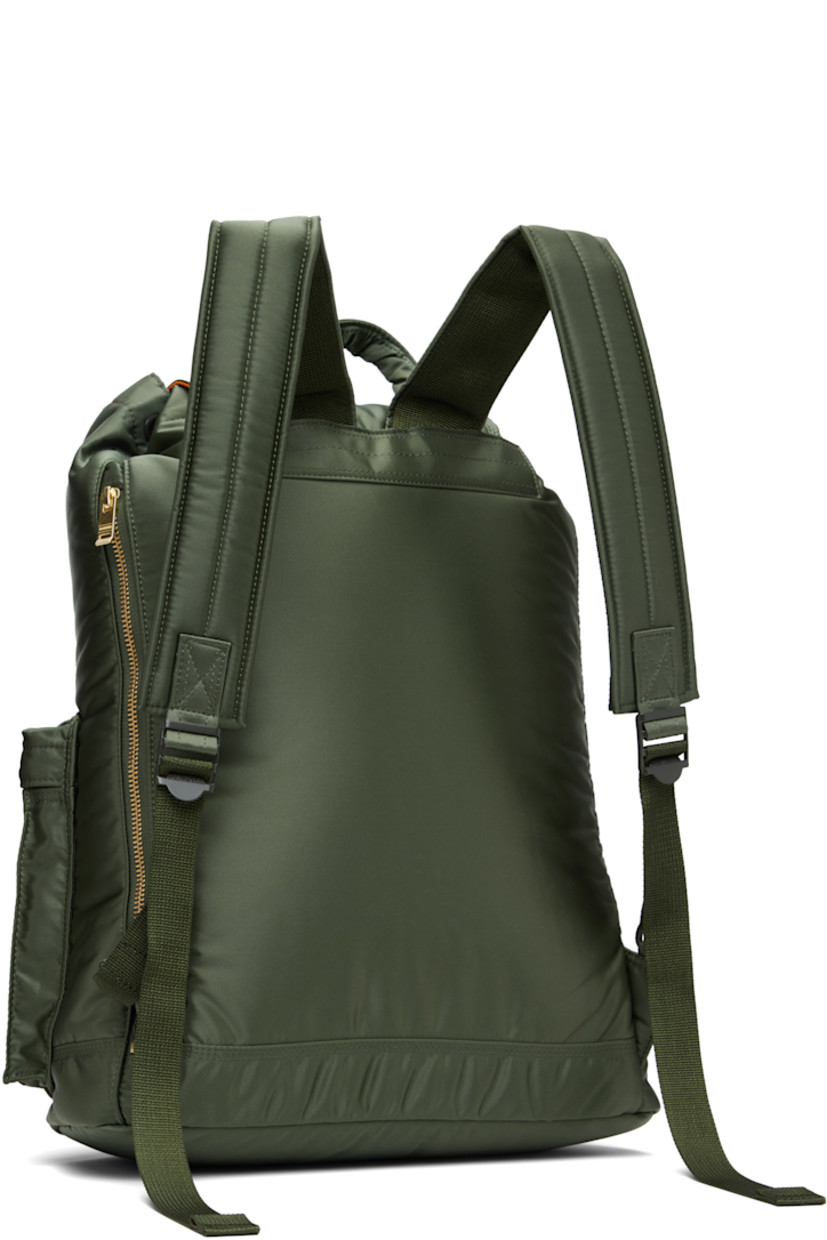 Nylon twill backpack in khaki.

· Padded carry handle
· Adjustable padded shoulder straps
· Zip compartments and logo patch at face
· Zip closure at padded back face
· Flap with press-stud fastening
· Cord-lock drawstring closure
· Patch pocket at interior
· Taffeta lining
· Logo-engraved gold-tone hardware
· H17" x W13" x D5" / 14 L

Supplier color: Sage green