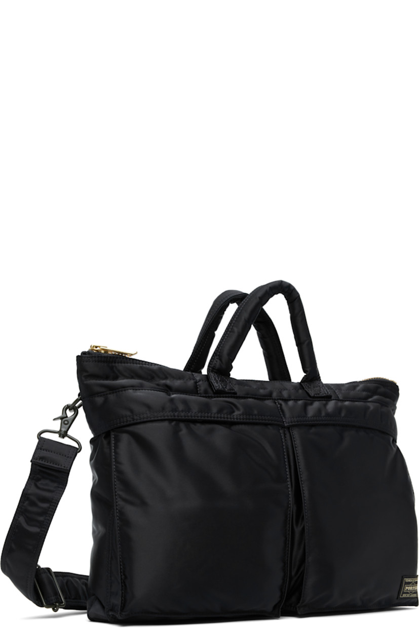 Nylon twill briefcase in navy.

· Padded carry handles
· Adjustable and detachable crossbody strap
· Bellows pockets and logo patch at face
· Zip closure
· Patch pockets at interior
· Taffeta lining
· Logo-engraved gold-tone hardware
· H12" x W16" x D1.5"

Supplier color: Iron blue