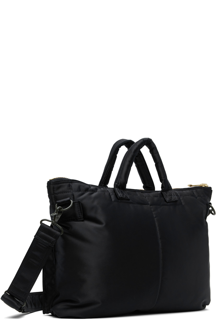 Nylon twill briefcase in navy.

· Padded carry handles
· Adjustable and detachable crossbody strap
· Bellows pockets and logo patch at face
· Zip closure
· Patch pockets at interior
· Taffeta lining
· Logo-engraved gold-tone hardware
· H12" x W16" x D1.5"

Supplier color: Iron blue
