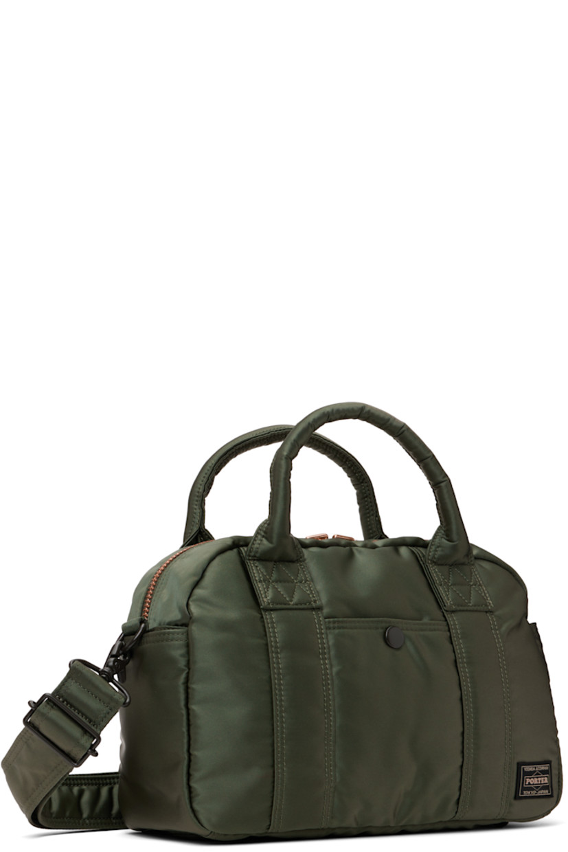Nylon twill messenger bag in khaki.

· Rolled carry handles
· Adjustable and detachable crossbody strap
· Patch pocket at face, sides, and back face
· Logo patch at face
· Bumper studs at base
· Two-way zip closure
· Patch pockets at interior
· Taffeta lining
· Logo-engraved gold-tone hardware
· H8.25" x W11.5" x D4.5"

Supplier color: Sage green