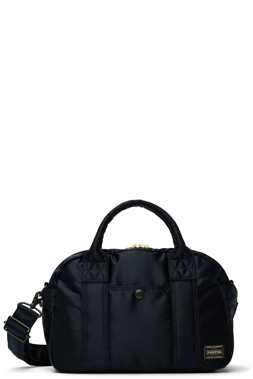 Nylon twill messenger bag in navy.

· Rolled carry handles
· Adjustable and detachable crossbody strap
· Patch pocket at face, sides, and back face
· Logo patch at face
· Bumper studs at base
· Two-way zip closure
· Patch pockets at interior
· Taffeta lining
· Logo-engraved gold-tone hardware
· H8.25" x W11.5" x D4.5"

Supplier color: Iron blue