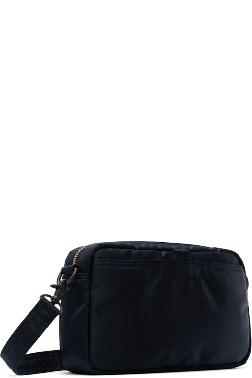 Nylon twill messenger bag in navy.

· Adjustable and detachable crossbody strap
· Bellows pockets and logo patch at face
· Patch pocket at back face
· Zip closure
· Patch pocket at interior
· Taffeta lining
· Logo-engraved gold-tone hardware
· H6" x W9" x D1.75"

Supplier color: Iron blue