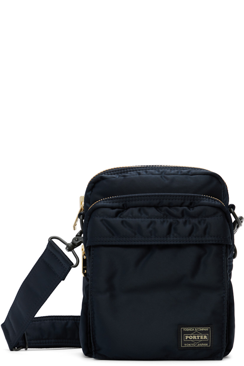 Nylon twill messenger bag in navy.

· Adjustable and detachable crossbody strap
· Logo patch at face
· Bellows and zip pocket
· Patch pocket at back face
· Zip closure
· Patch pocket at interior
· Taffeta lining
· Logo-engraved gold-tone hardware
· H8" x W6" x D3"

Supplier color: Iron blue