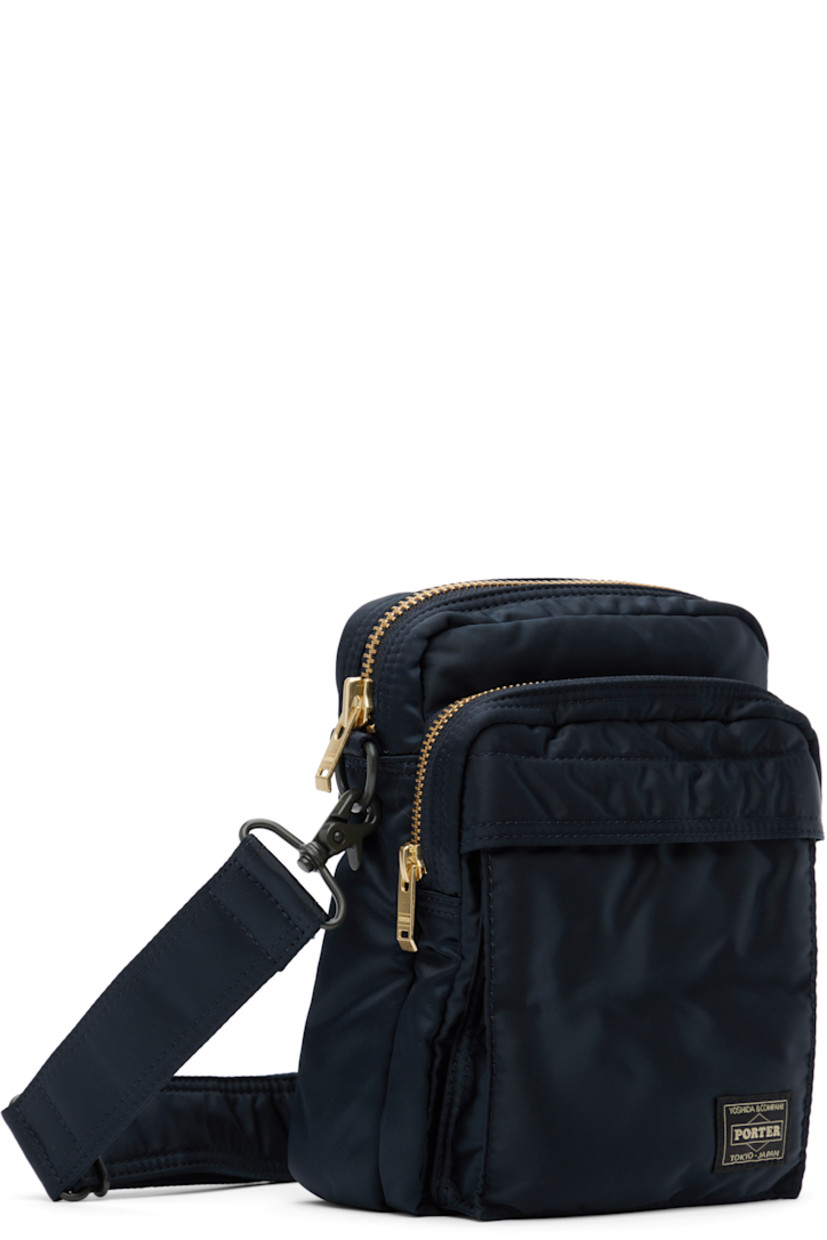 Nylon twill messenger bag in navy.

· Adjustable and detachable crossbody strap
· Logo patch at face
· Bellows and zip pocket
· Patch pocket at back face
· Zip closure
· Patch pocket at interior
· Taffeta lining
· Logo-engraved gold-tone hardware
· H8" x W6" x D3"

Supplier color: Iron blue