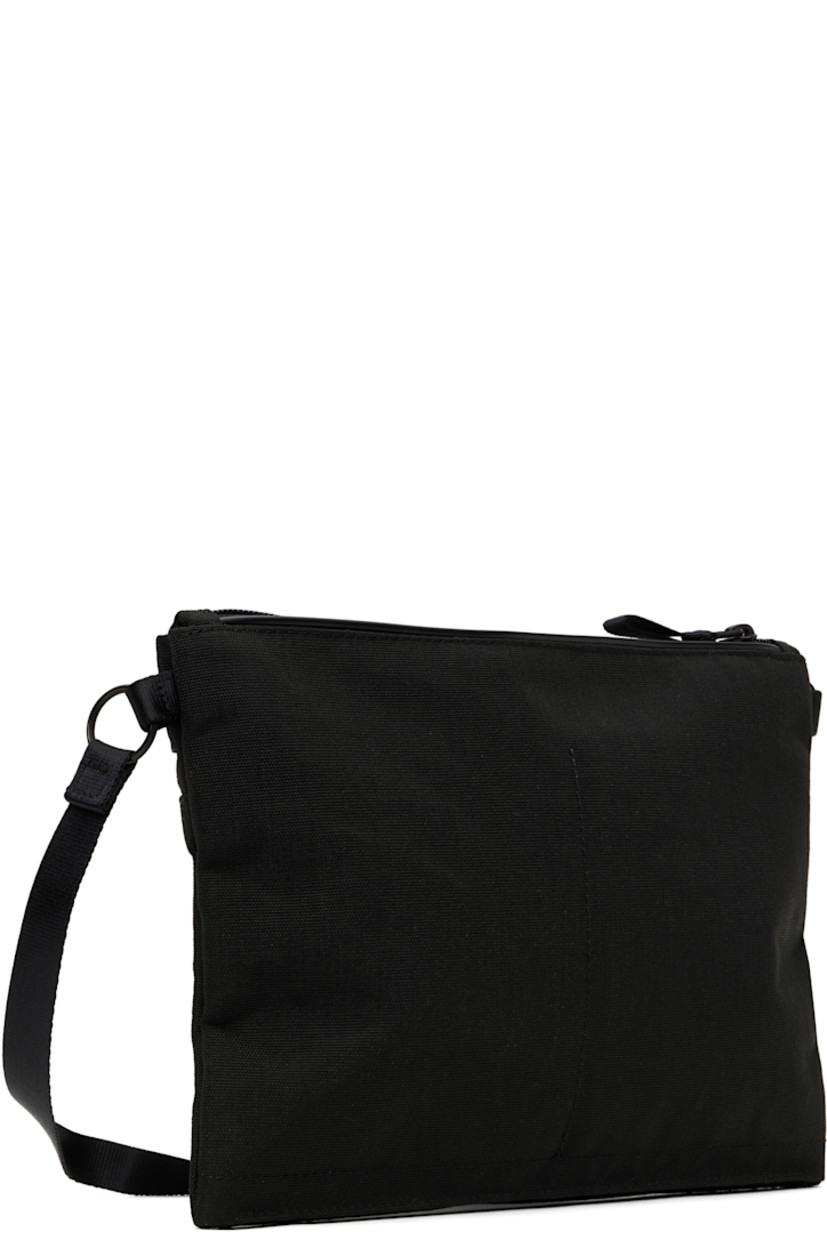 X-C1000 nylon canvas pouch in black.

· Lightweight and waterproof
· Adjustable and detachable crossbody strap
· Logo patch at face
· Zip pocket
· Zip closure
· Patch pockets at interior
· 1000 denier CORDURA® canvas lining 
· H7.5" x W10" x D1"

Part of the Hybrid collection.

Supplier color: Black