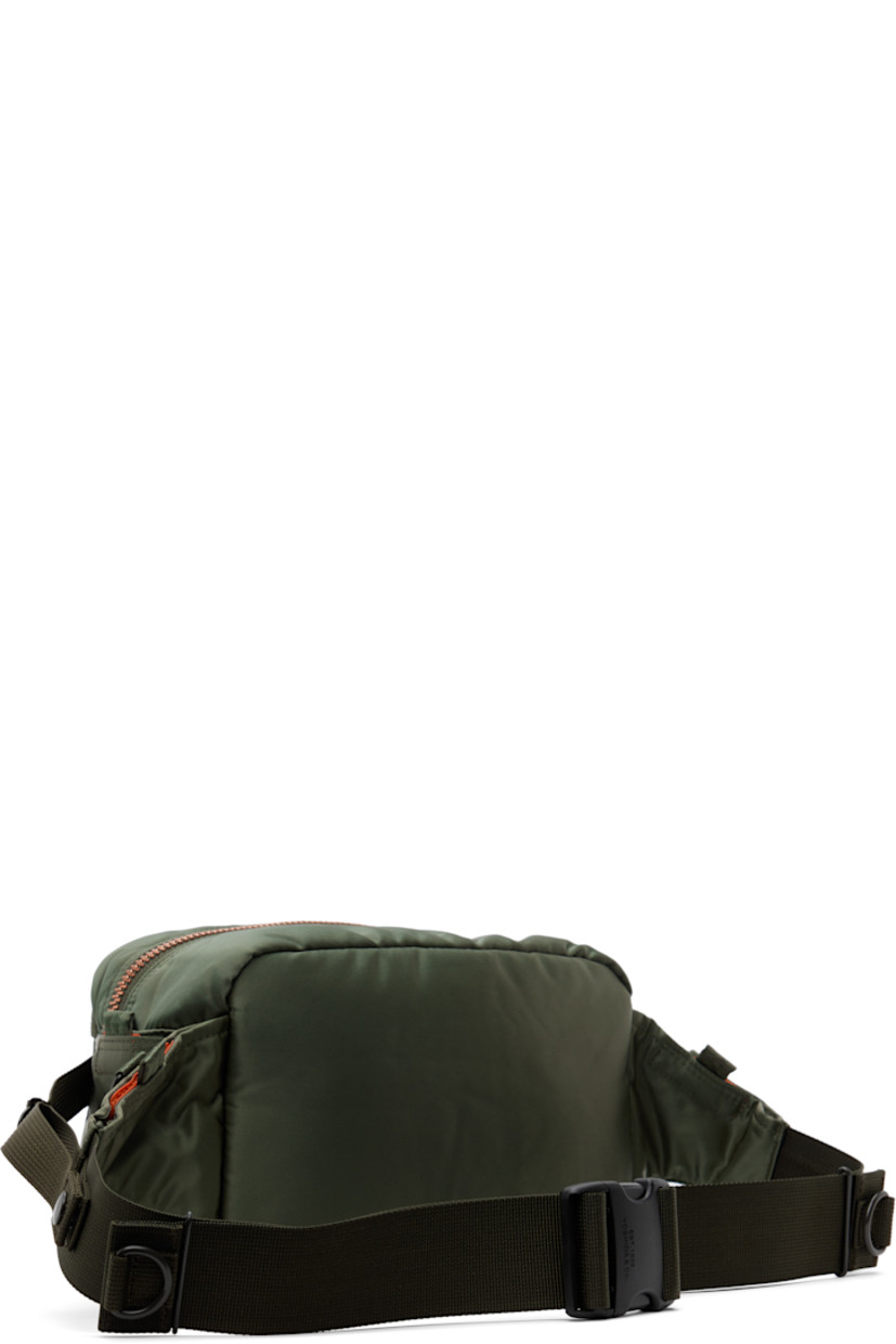 Nylon twill belt bag in khaki.

· Adjustable webbing belt-style crossbody strap
· D-rings and patch pockets at strap
· Bellows pockets and logo patch at face
· Patch pocket and cinch strap at sides
· Zip closure
· Patch pocket at interior
· Taffeta lining
· Logo-engraved gold-tone hardware
· H6.5" x W10.5" x D5"

Supplier color: Sage green