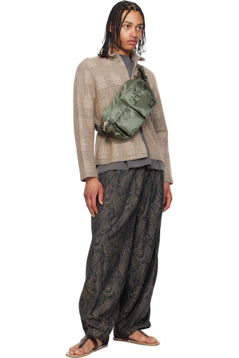 Nylon twill belt bag in khaki.

· Adjustable webbing belt-style crossbody strap
· D-rings and patch pockets at strap
· Bellows pockets and logo patch at face
· Patch pocket and cinch strap at sides
· Zip closure
· Patch pocket at interior
· Taffeta lining
· Logo-engraved gold-tone hardware
· H6.5" x W10.5" x D5"

Supplier color: Sage green