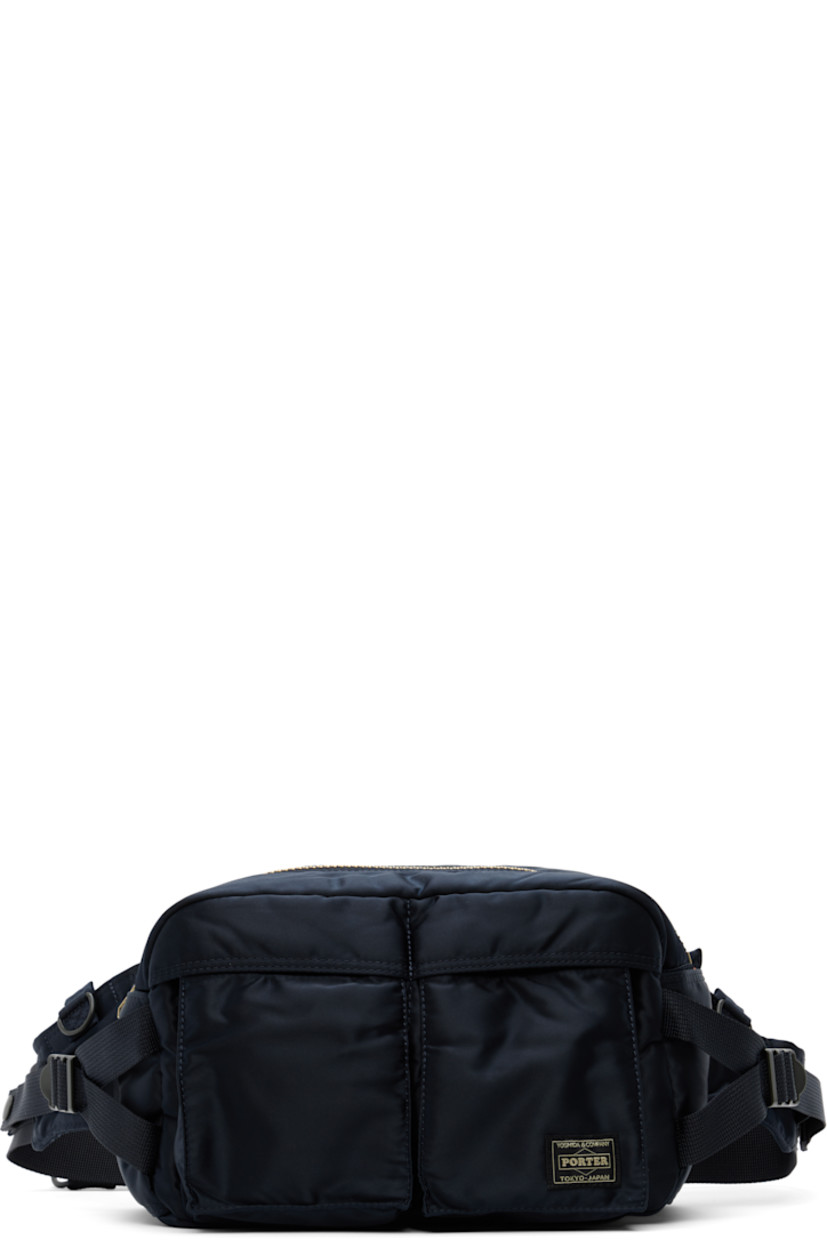 Nylon twill belt bag in navy.

· Adjustable webbing belt-style crossbody strap
· D-rings and patch pockets at strap
· Bellows pockets and logo patch at face
· Patch pocket and cinch strap at sides
· Zip closure
· Patch pocket at interior
· Taffeta lining
· Logo-engraved gold-tone hardware
· H6.5" x W10.5" x D5"

Supplier color: Iron blue