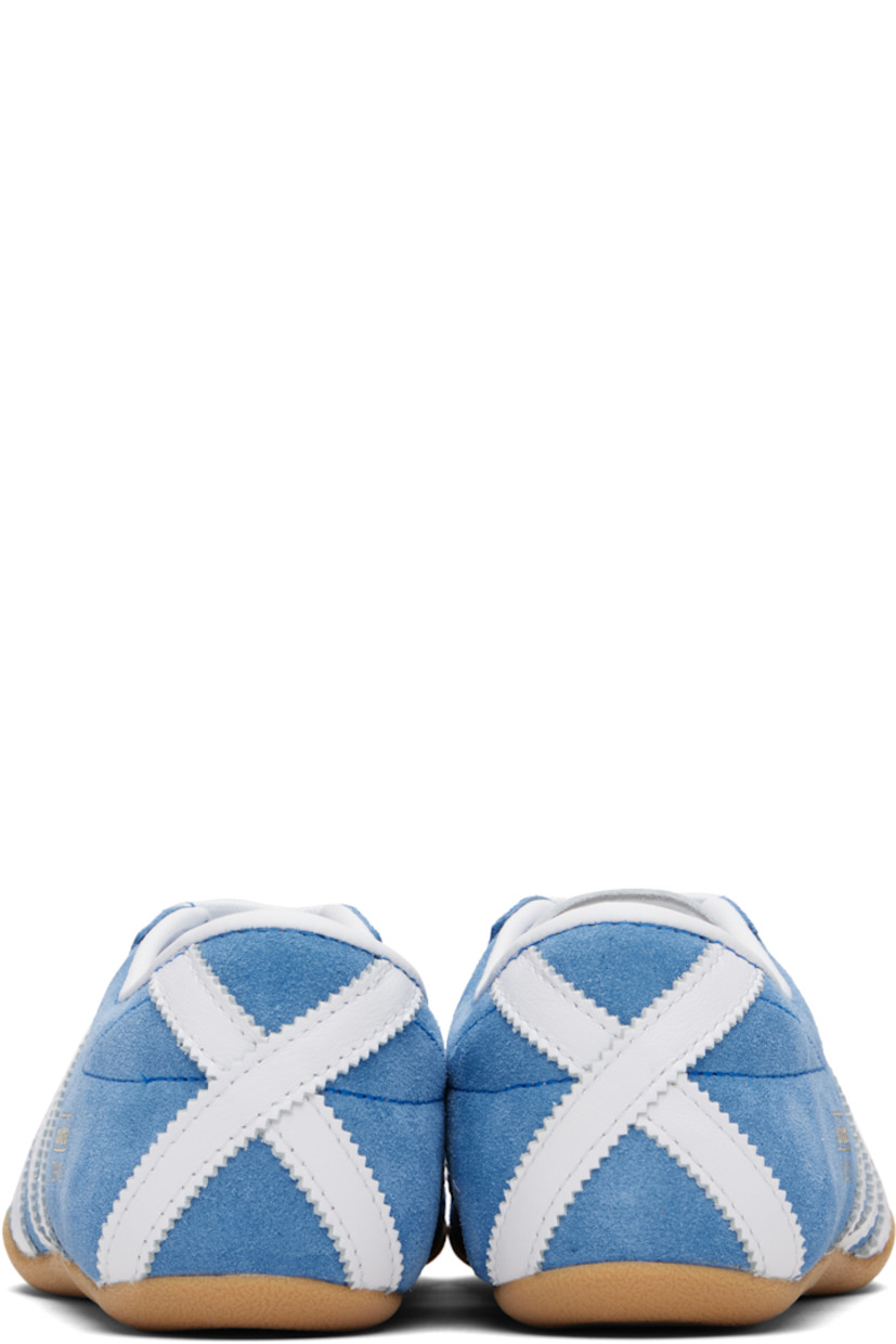 Low-top suede sneakers.

· Lace-up closure
· Logo embossed at tongue
· Padded collar
· Signature serrated stripes at sides and heel
· Logo stamp at outer side
· Leather lining
· Textured rubber sole

Supplier color: Blue bird/Cloud white/Gum
