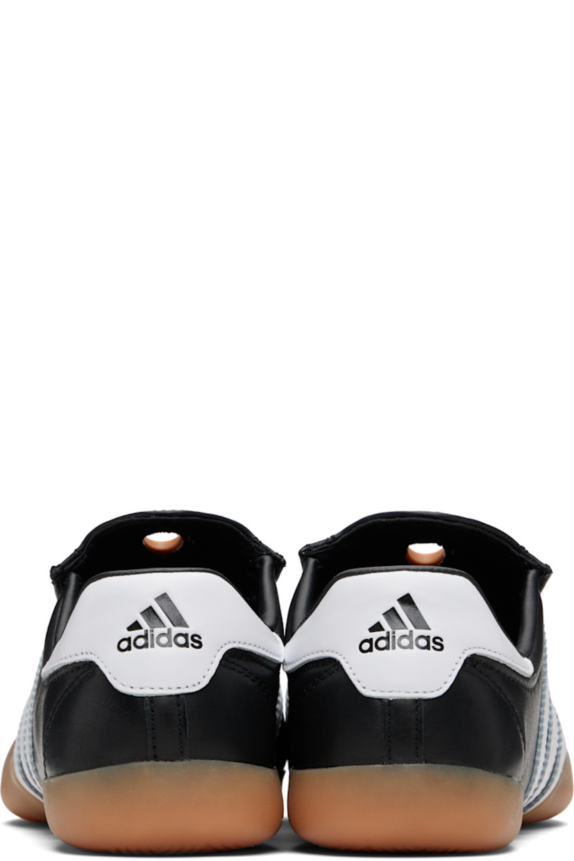 Low-top buffed leather slip-on sneakers.

· Rubber eyelet at tongue
· Padded collar
· Signature serrated stripes at sides
· Logo embossed at heel tab
· Treaded rubber sole

Supplier color: Core black/Cloud white/Gum