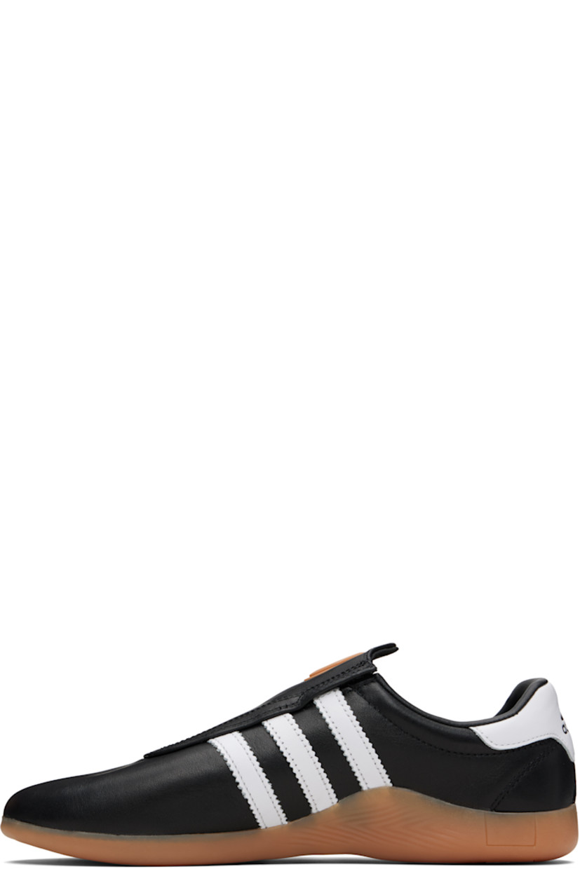 Low-top buffed leather slip-on sneakers.

· Rubber eyelet at tongue
· Padded collar
· Signature serrated stripes at sides
· Logo embossed at heel tab
· Treaded rubber sole

Supplier color: Core black/Cloud white/Gum