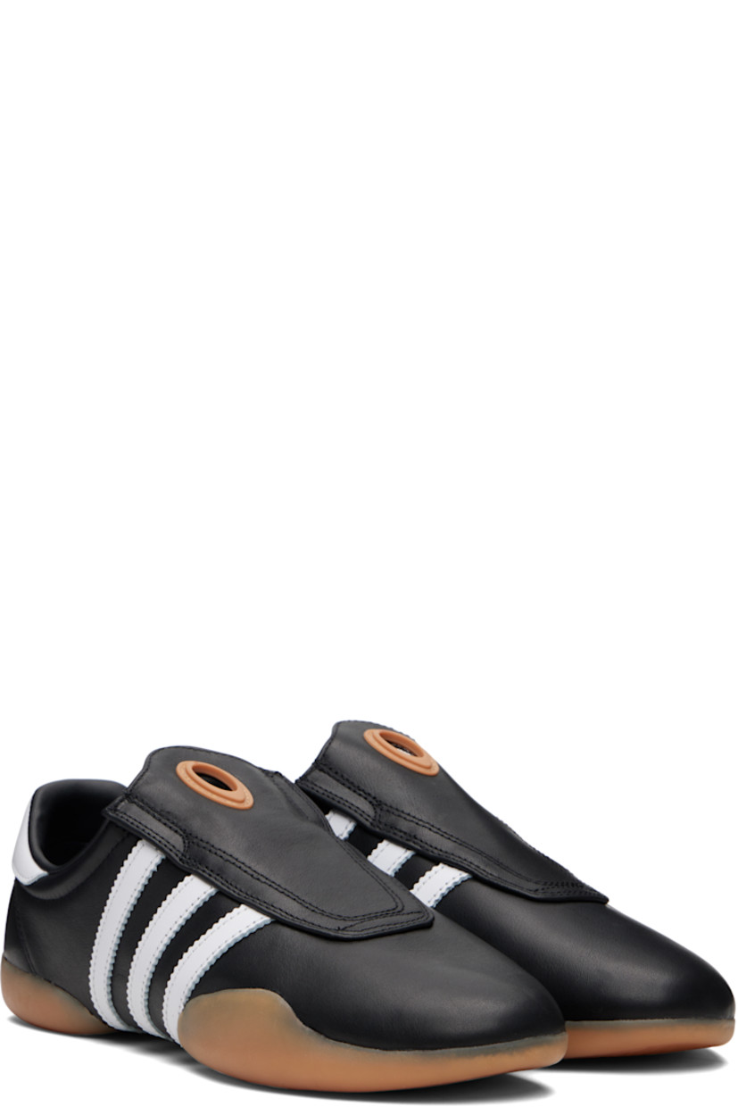 Low-top buffed leather slip-on sneakers.

· Rubber eyelet at tongue
· Padded collar
· Signature serrated stripes at sides
· Logo embossed at heel tab
· Treaded rubber sole

Supplier color: Core black/Cloud white/Gum