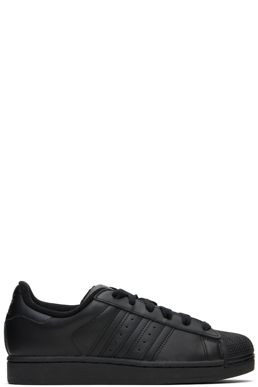 Low-top buffed leather sneakers.

· Textured rubber cap toe
· Lace-up closure
· Logo embossed at tongue and heel tab
· Padded tongue and collar
· Text printed at outer side
· Perforations and signature serrated stripes at sides
· Terrycloth lining
· Treaded rubber sole

Supplier color: Core black/Core black/Core black