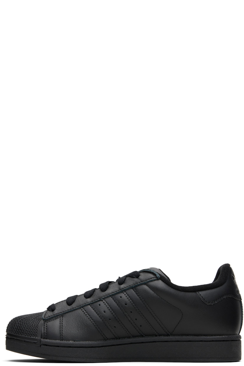 Low-top buffed leather sneakers.

· Textured rubber cap toe
· Lace-up closure
· Logo embossed at tongue and heel tab
· Padded tongue and collar
· Text printed at outer side
· Perforations and signature serrated stripes at sides
· Terrycloth lining
· Treaded rubber sole

Supplier color: Core black/Core black/Core black