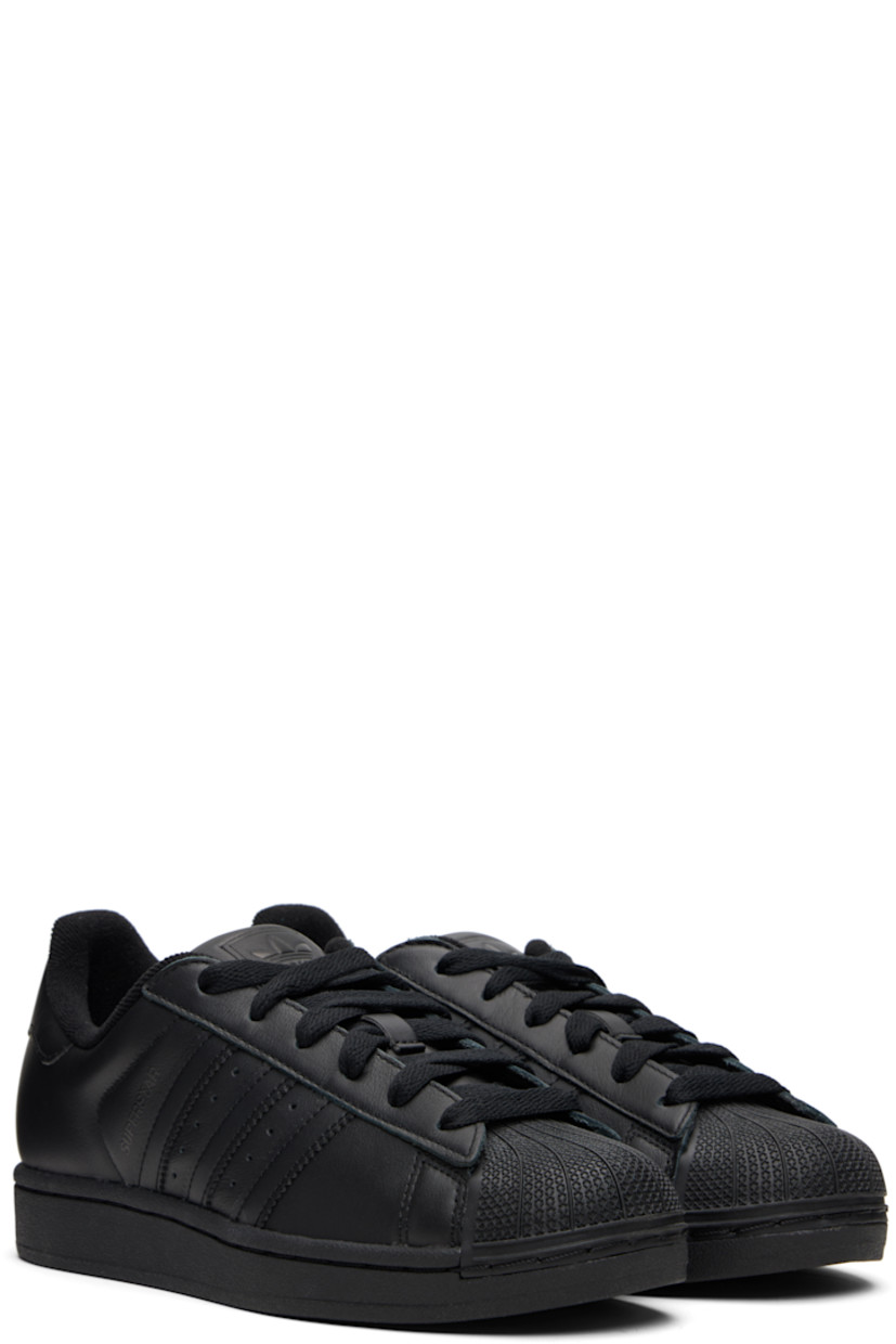 Low-top buffed leather sneakers.

· Textured rubber cap toe
· Lace-up closure
· Logo embossed at tongue and heel tab
· Padded tongue and collar
· Text printed at outer side
· Perforations and signature serrated stripes at sides
· Terrycloth lining
· Treaded rubber sole

Supplier color: Core black/Core black/Core black