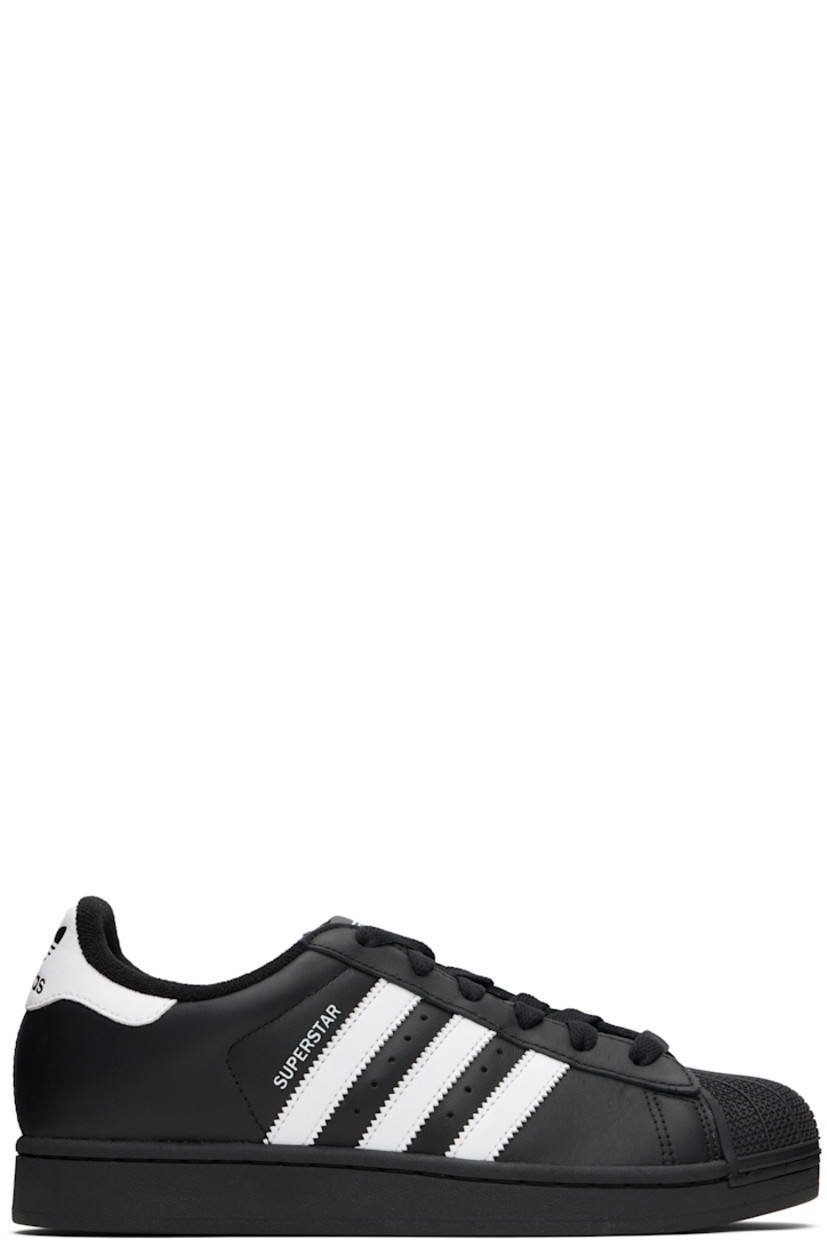 Low-top buffed leather sneakers.

· Textured rubber cap toe
· Lace-up closure
· Logo embossed at tongue and heel tab
· Padded tongue and collar
· Text printed at outer side
· Perforations and signature serrated stripes at sides
· Terrycloth lining
· Treaded rubber sole

Supplier color: Core black/Cloud white/Core black