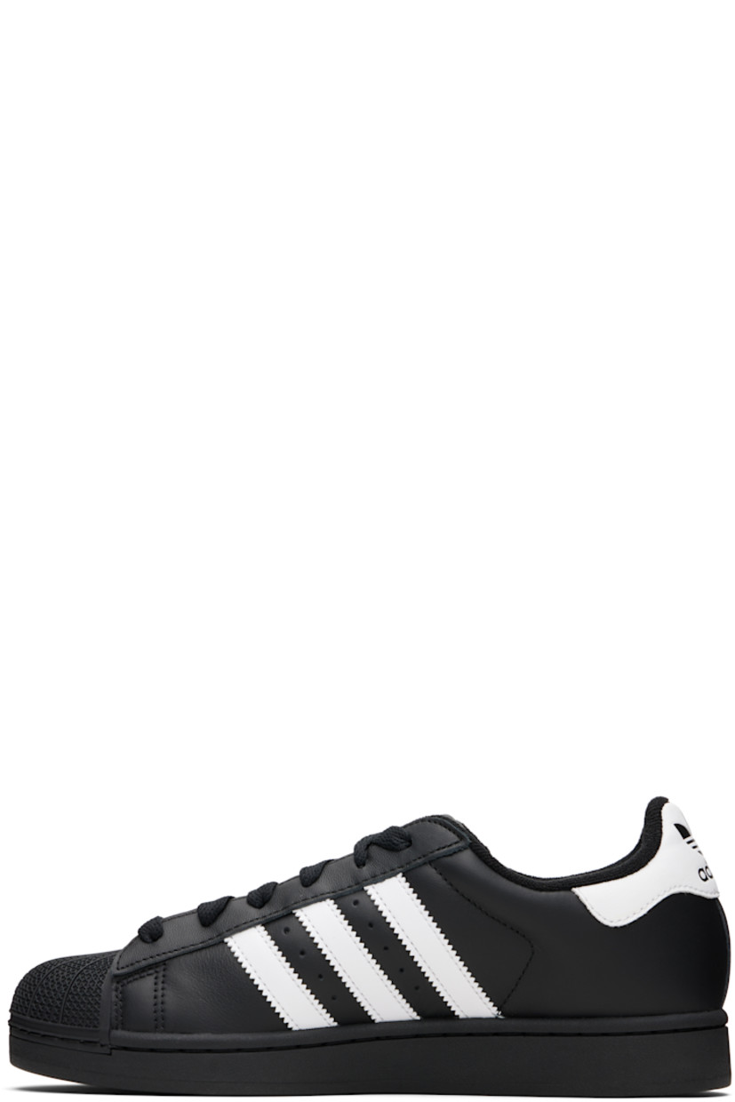 Low-top buffed leather sneakers.

· Textured rubber cap toe
· Lace-up closure
· Logo embossed at tongue and heel tab
· Padded tongue and collar
· Text printed at outer side
· Perforations and signature serrated stripes at sides
· Terrycloth lining
· Treaded rubber sole

Supplier color: Core black/Cloud white/Core black