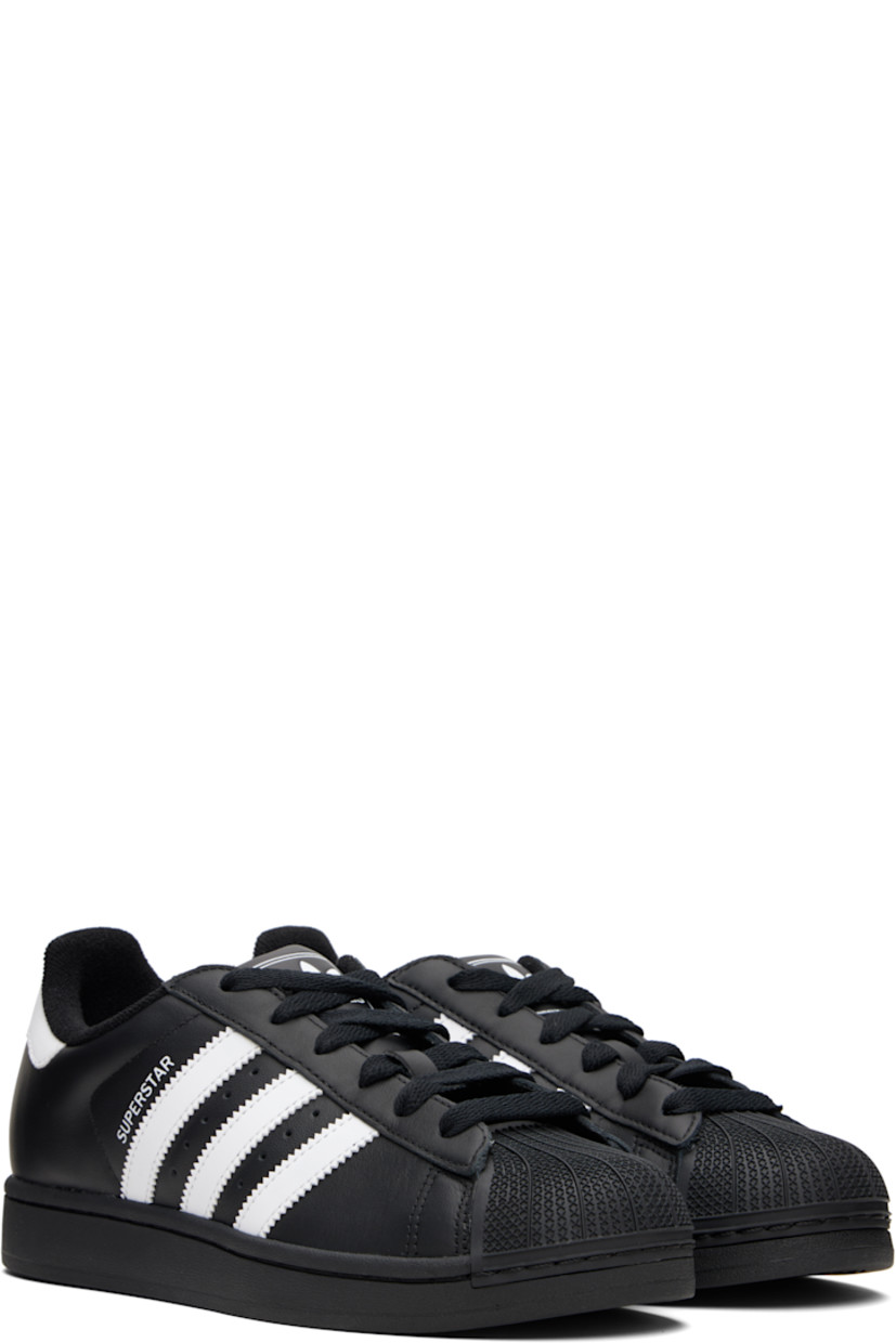 Low-top buffed leather sneakers.

· Textured rubber cap toe
· Lace-up closure
· Logo embossed at tongue and heel tab
· Padded tongue and collar
· Text printed at outer side
· Perforations and signature serrated stripes at sides
· Terrycloth lining
· Treaded rubber sole

Supplier color: Core black/Cloud white/Core black
