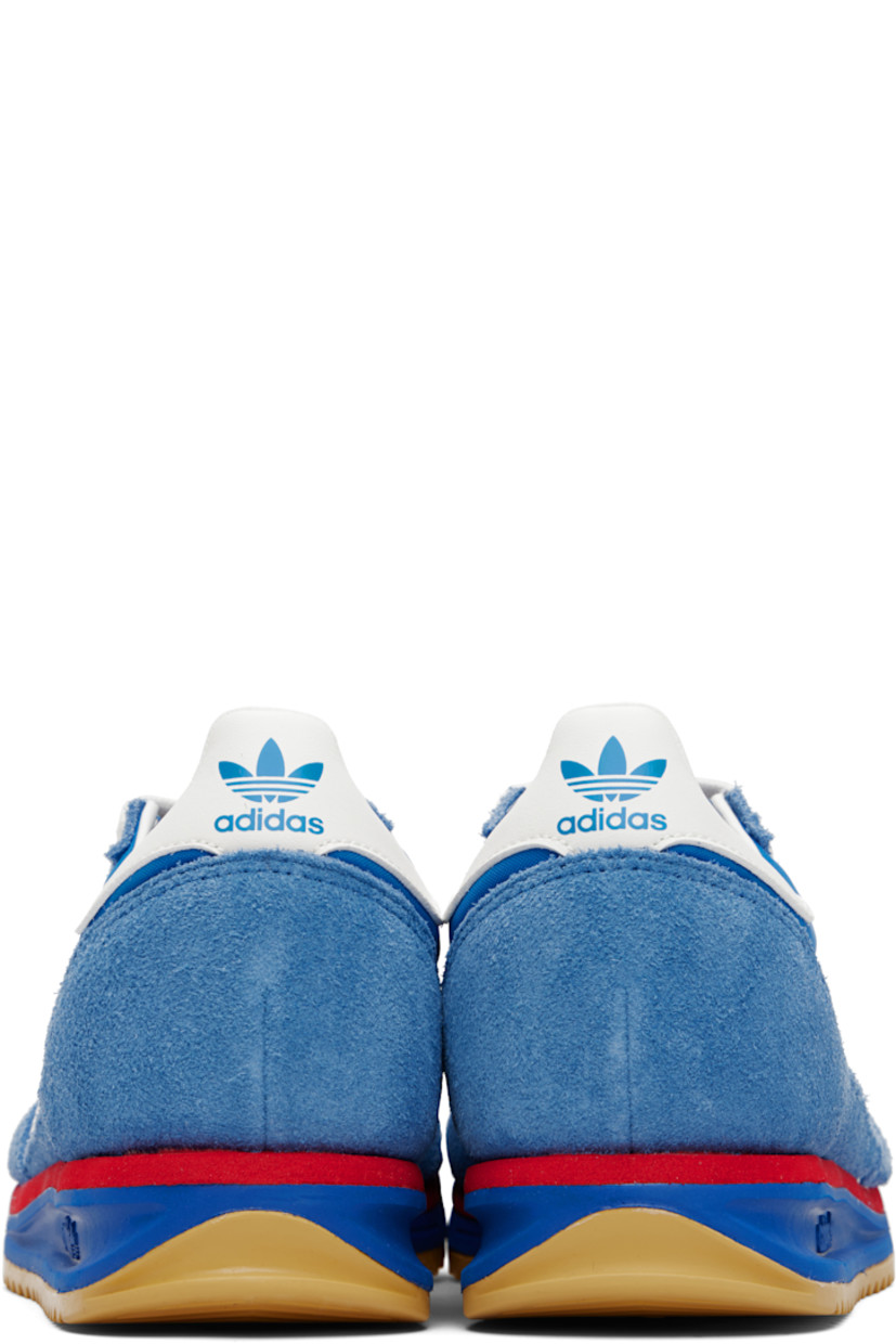 Low-top suede and canvas sneakers.

· Lace-up closure
· Logo printed at textured tongue
· Padded collar
· Signature serrated stripes at sides
· Logo and text stamp at outer side
· Logo printed at heel tab
· Mesh lining
· Logo embossed at foam rubber midsole
· Treaded rubber sole

Supplier color: Blue/Core white/Better scarlet