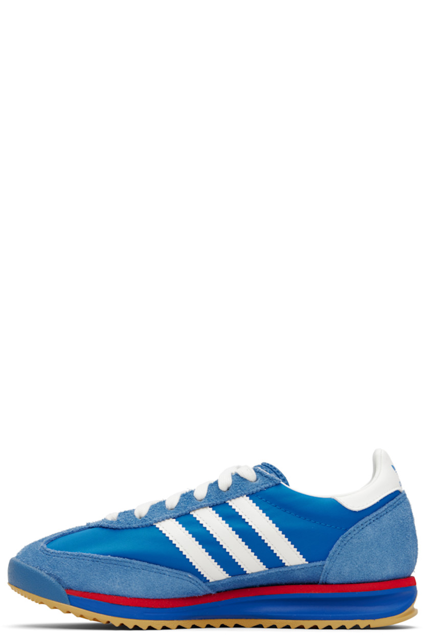 Low-top suede and canvas sneakers.

· Lace-up closure
· Logo printed at textured tongue
· Padded collar
· Signature serrated stripes at sides
· Logo and text stamp at outer side
· Logo printed at heel tab
· Mesh lining
· Logo embossed at foam rubber midsole
· Treaded rubber sole

Supplier color: Blue/Core white/Better scarlet