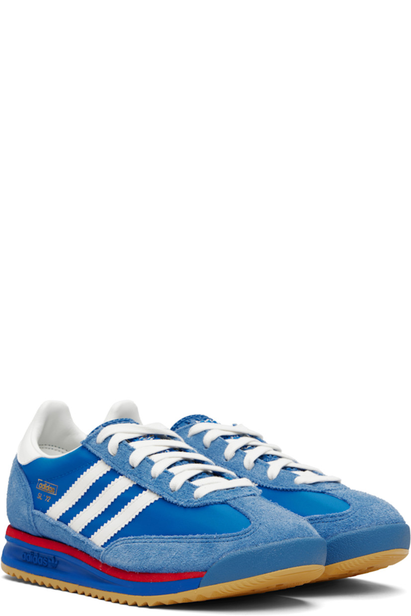 Low-top suede and canvas sneakers.

· Lace-up closure
· Logo printed at textured tongue
· Padded collar
· Signature serrated stripes at sides
· Logo and text stamp at outer side
· Logo printed at heel tab
· Mesh lining
· Logo embossed at foam rubber midsole
· Treaded rubber sole

Supplier color: Blue/Core white/Better scarlet