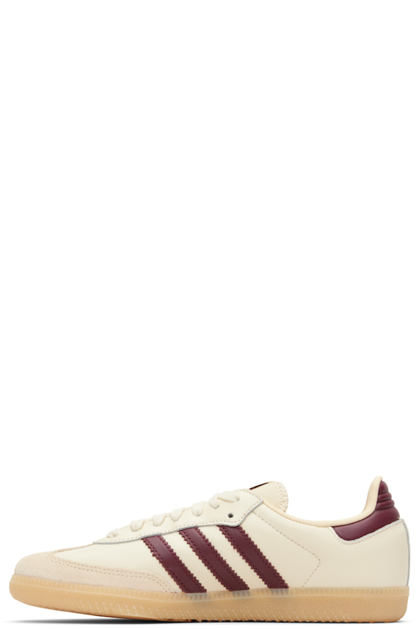 Low-top buffed leather sneakers.

· Suede trim at toe
· Lace-up closure
· Logo patch at padded tongue
· Padded collar
· Text stamp at outer side
· Signature serrated stripes at sides
· Quilted heel tab
· Mesh lining
· Treaded rubber sole

Supplier color: Wonder white/Shadow red/Gum