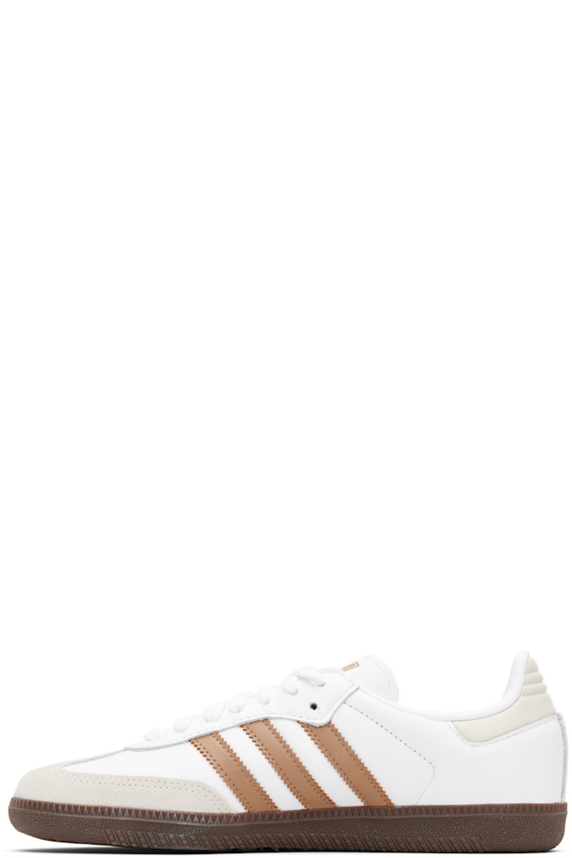 Low-top buffed leather sneakers.

· Suede trim at toe
· Lace-up closure
· Logo printed at tongue
· Padded collar
· Text stamp at outer side
· Signature serrated stripes at sides
· Quilted heel tab
· Mesh lining
· Treaded rubber sole

Supplier color: Cloud white/Cardboard/Gum