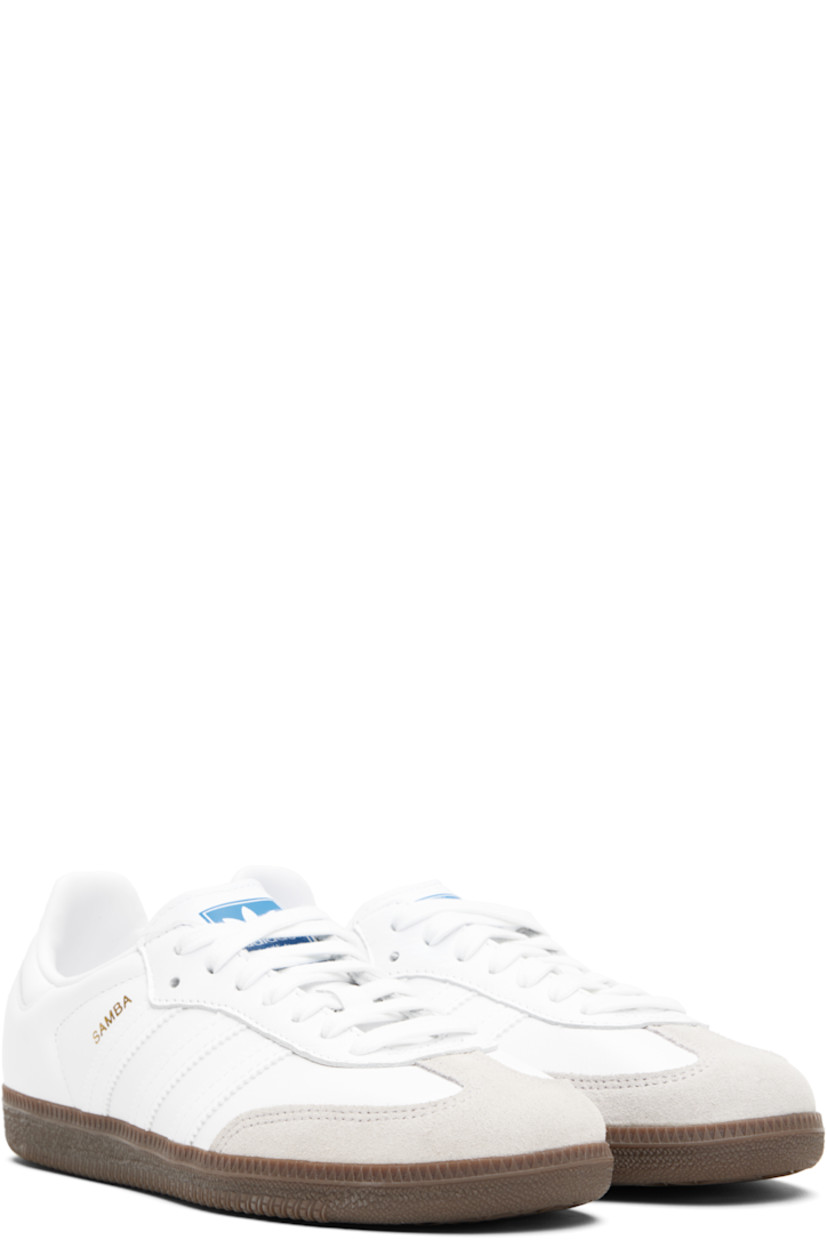 Low-top buffed leather sneakers.

· Suede trim at toe
· Lace-up closure
· Logo printed at tongue
· Padded collar
· Text stamp at outer side
· Signature serrated stripes at sides
· Quilted heel tab
· Mesh lining
· Treaded rubber sole

Supplier color: Cloud white/Cloud white/Gum