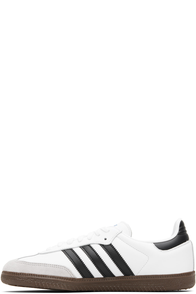 Low-top buffed leather sneakers.

· Suede trim at toe
· Lace-up closure
· Logo printed at tongue
· Padded collar
· Text stamp at outer side
· Signature serrated stripes at sides
· Quilted heel tab
· Mesh lining
· Treaded rubber sole

Supplier color: Cloud white/Core black/Clear granite