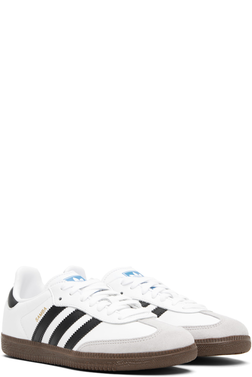 Low-top buffed leather sneakers.

· Suede trim at toe
· Lace-up closure
· Logo printed at tongue
· Padded collar
· Text stamp at outer side
· Signature serrated stripes at sides
· Quilted heel tab
· Mesh lining
· Treaded rubber sole

Supplier color: Cloud white/Core black/Clear granite