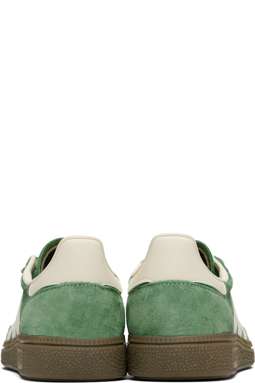 Low-top faux-suede and buffed faux-leather sneakers.

· Lace-up closure
· Logo patch at tongue
· Padded tongue and collar
· Signature serrated stripes at sides
· Text and logo stamp at outer side
· Treaded rubber sole

Supplier color: Preloved green/Cream white/Crystal white