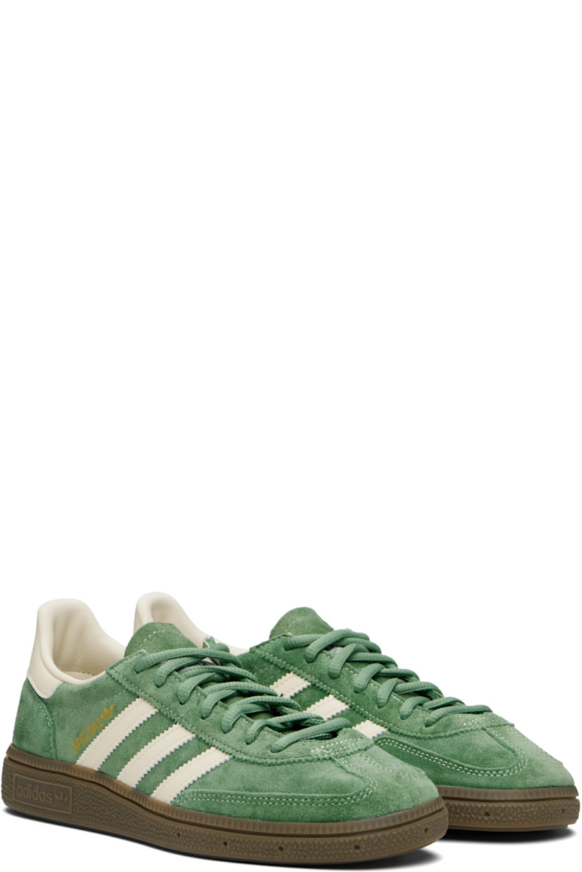 Low-top faux-suede and buffed faux-leather sneakers.

· Lace-up closure
· Logo patch at tongue
· Padded tongue and collar
· Signature serrated stripes at sides
· Text and logo stamp at outer side
· Treaded rubber sole

Supplier color: Preloved green/Cream white/Crystal white