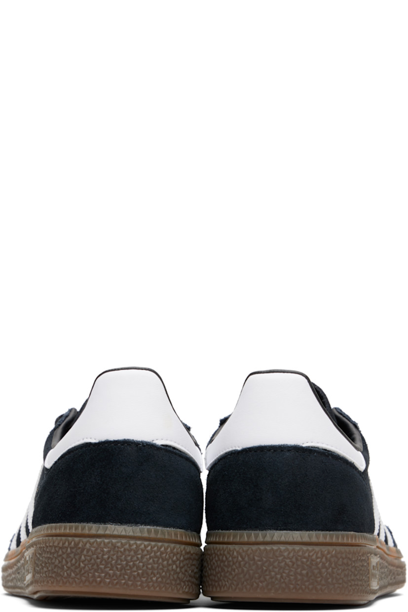 Low-top suede sneakers.

· Lace-up closure
· Logo patch at tongue
· Padded collar
· Text and logo stamp at outer side
· Signature serrated stripes at sides
· Mesh lining
· Treaded rubber sole

Supplier color: Core black/Cloud white/Gum