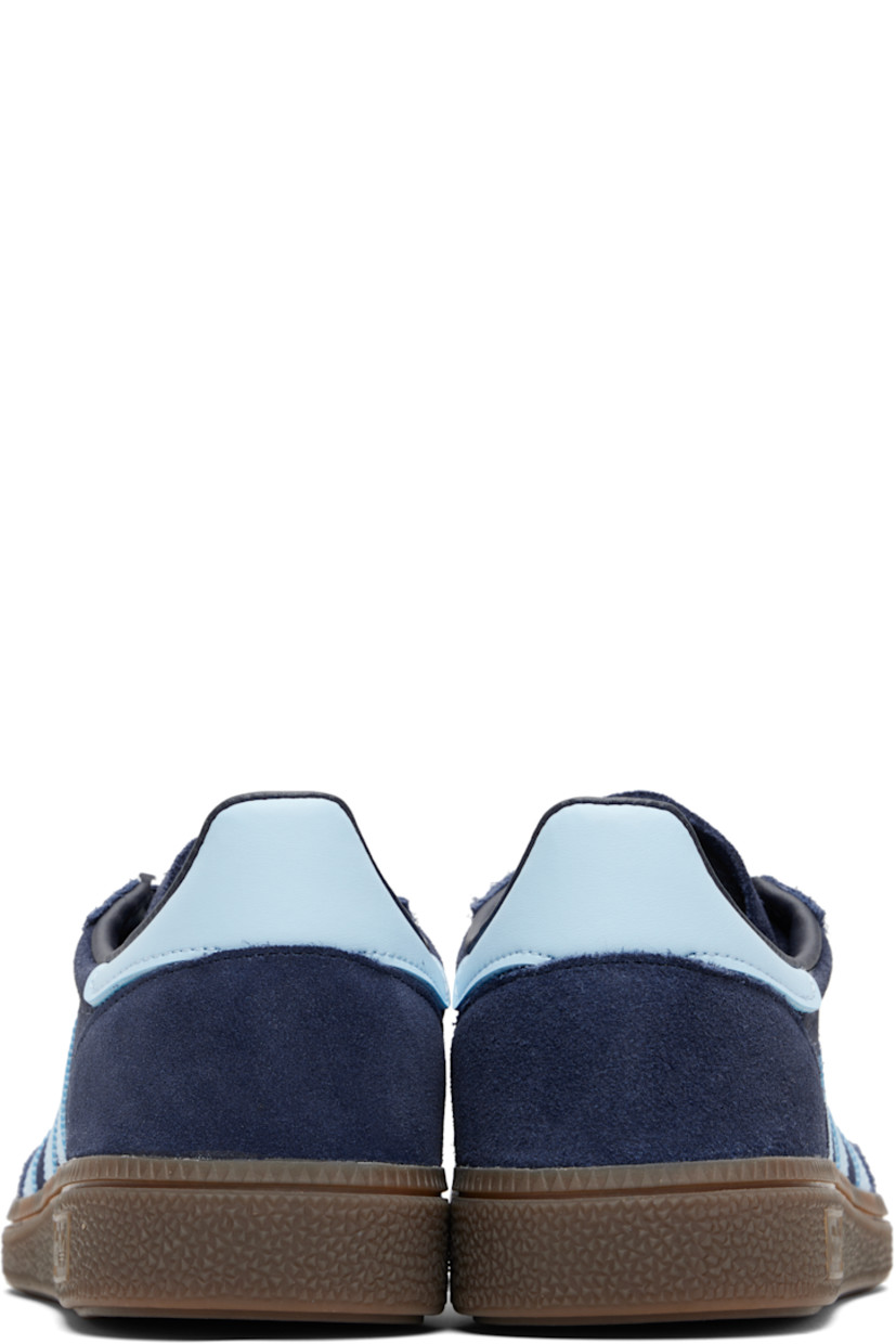 Low-top suede sneakers.

· Lace-up closure
· Logo patch at tongue
· Padded collar
· Text and logo stamp at outer side
· Signature serrated stripes at sides
· Mesh lining
· Treaded rubber sole

Supplier color: Collegiate navy/Clear sky/Gum