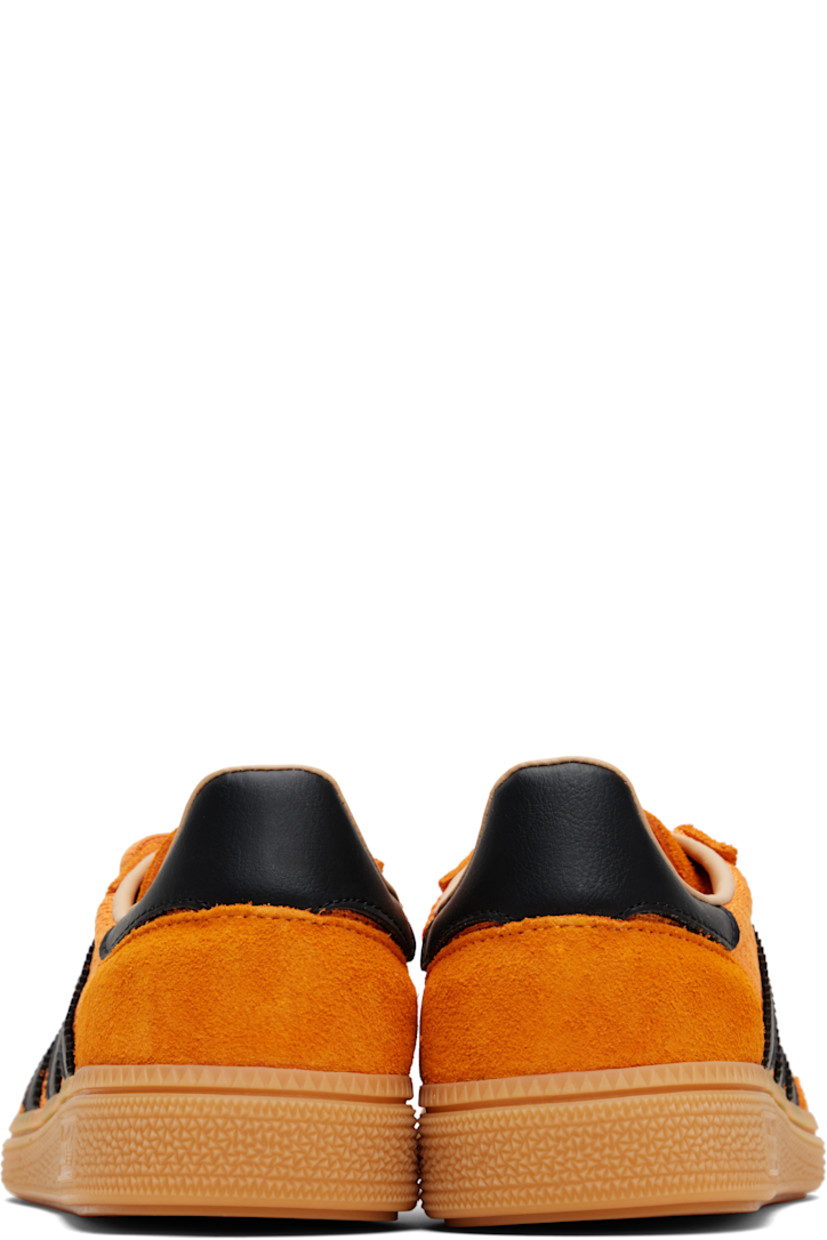 Low-top mesh and suede sneakers.

· Lace-up closure
· Logo patch at tongue
· Padded collar
· Signature serrated stripes at sides
· Mesh lining
· Treaded rubber sole

Supplier color: Crew orange/Core black/Warm sandstone