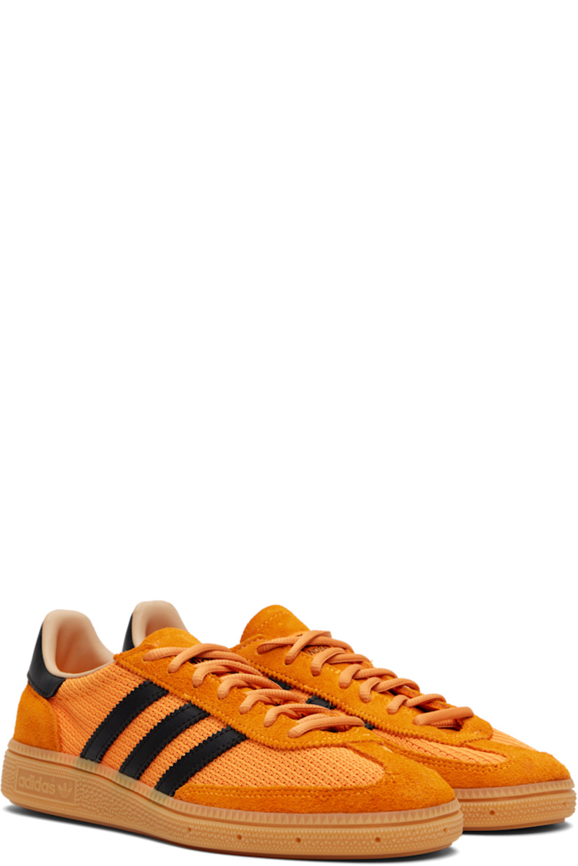 Low-top mesh and suede sneakers.

· Lace-up closure
· Logo patch at tongue
· Padded collar
· Signature serrated stripes at sides
· Mesh lining
· Treaded rubber sole

Supplier color: Crew orange/Core black/Warm sandstone