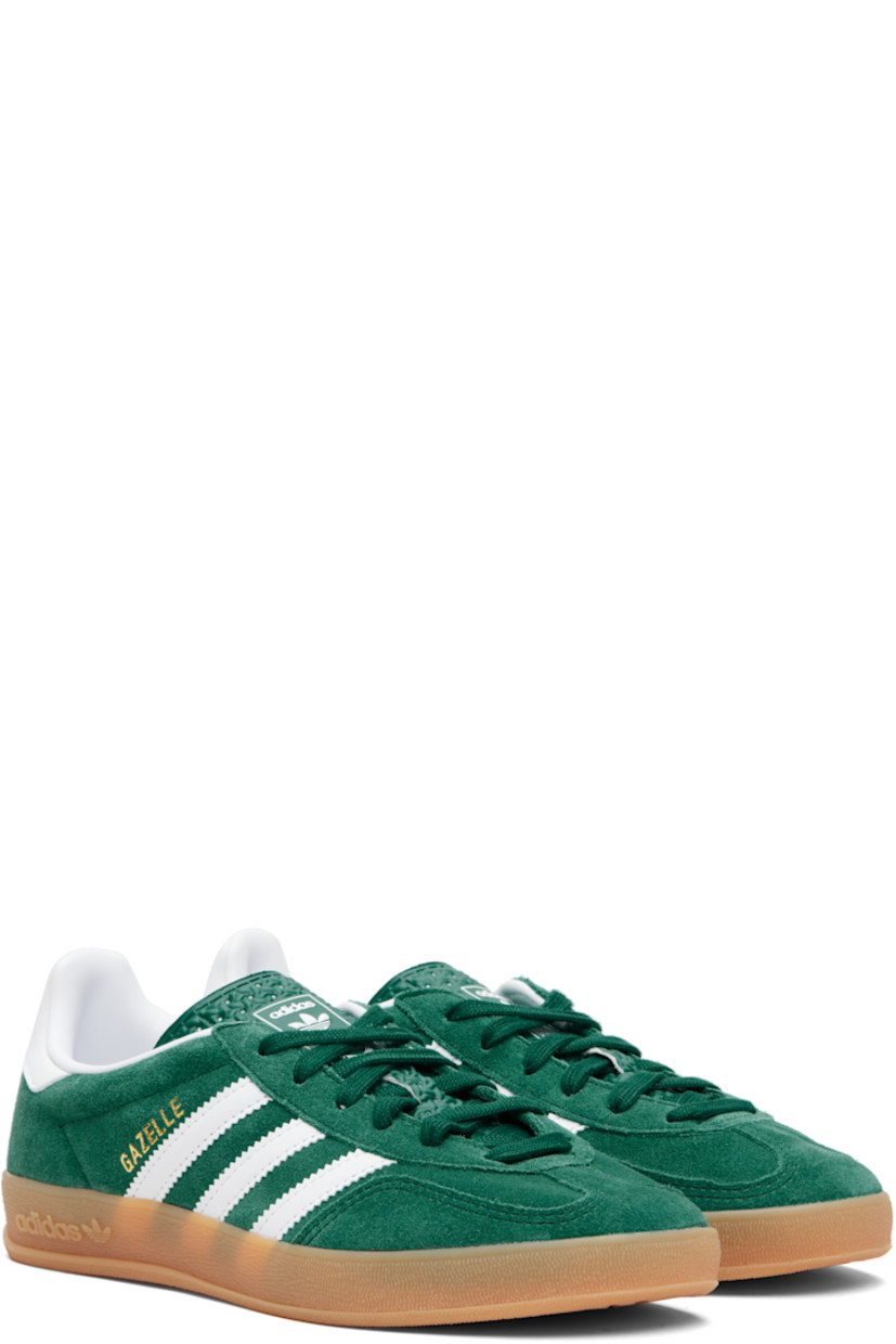 Low-top suede sneakers.

· Lace-up closure
· Logo printed at textured tongue
· Padded collar
· Text stamp at outer side
· Signature serrated stripes at sides
· Logo printed at heel tab
· Jersey lining
· Treaded rubber sole
· Includes alternate laces

Supplier color: Collegiate green/Cloud white/Gum