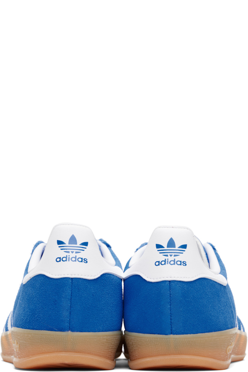 Low-top suede sneakers.

· Lace-up closure
· Logo printed at textured tongue
· Padded collar
· Text stamp at outer side
· Signature serrated stripes at sides
· Logo printed at heel tab
· Jersey lining
· Treaded rubber sole
· Includes alternate laces

Supplier color: Blue bird/Cloud white/Gum