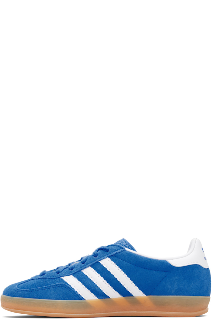 Low-top suede sneakers.

· Lace-up closure
· Logo printed at textured tongue
· Padded collar
· Text stamp at outer side
· Signature serrated stripes at sides
· Logo printed at heel tab
· Jersey lining
· Treaded rubber sole
· Includes alternate laces

Supplier color: Blue bird/Cloud white/Gum