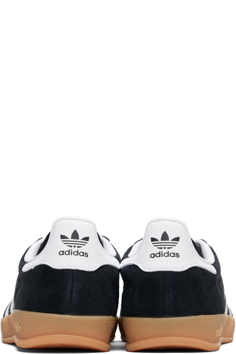 Low-top suede sneakers.

· Lace-up closure
· Logo printed at textured tongue
· Padded collar
· Text stamp at outer side
· Signature serrated stripes at sides
· Logo printed at heel tab
· Jersey lining
· Treaded rubber sole
· Includes alternate laces

Supplier color: Core black/Cloud white/Gum