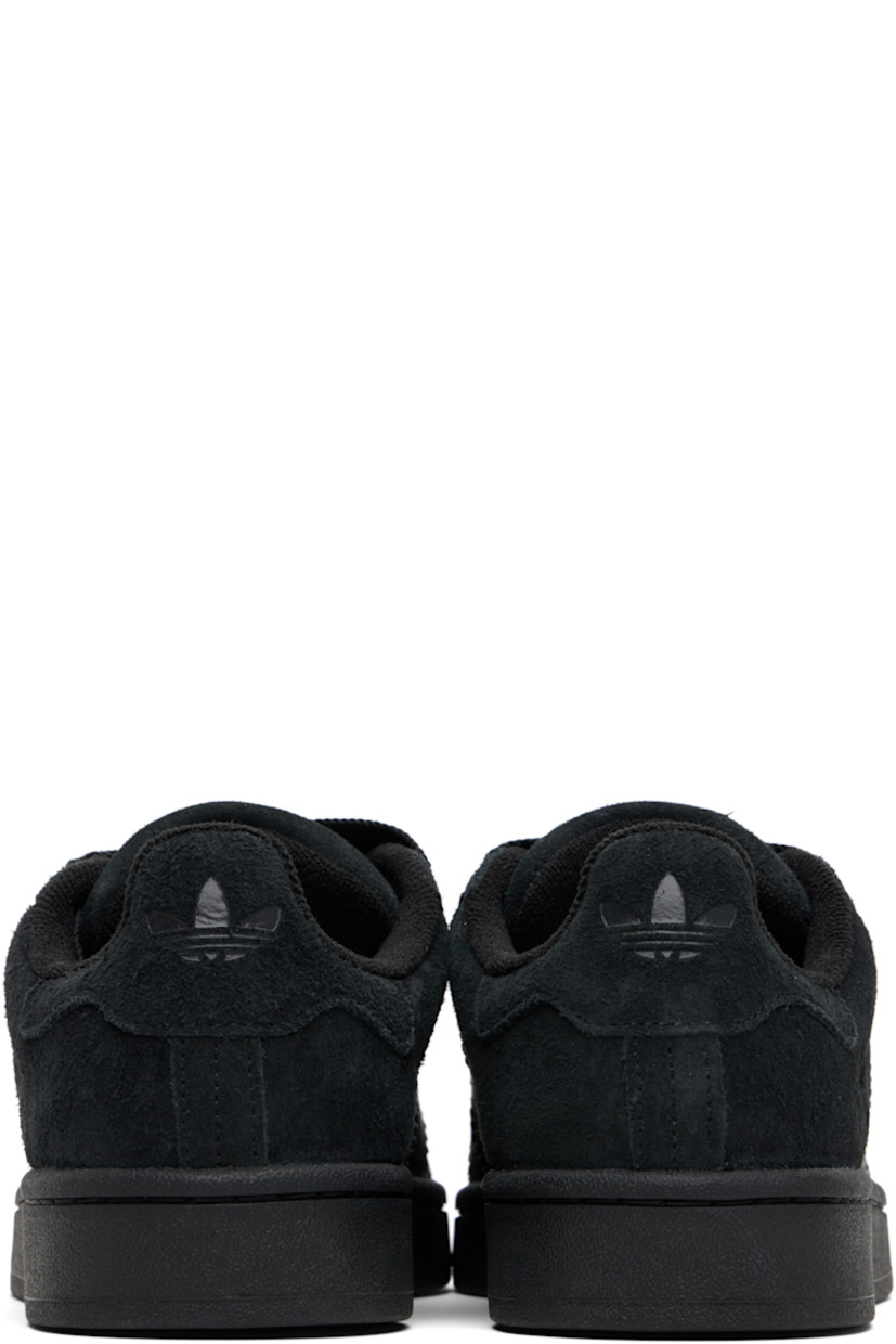 Low-top suede sneakers.

· Lace-up closure
· Padded tongue and collar
· Logo printed at tongue and heel tab
· Text printed at outer side
· Perforations and signature serrated stripes at sides
· Terrycloth and mesh lining
· Treaded rubber sole

Supplier color: Core black/Core black/Core black