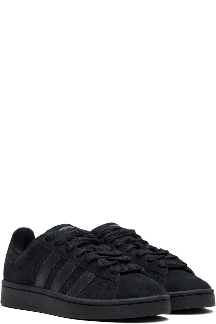 Low-top suede sneakers.

· Lace-up closure
· Padded tongue and collar
· Logo printed at tongue and heel tab
· Text printed at outer side
· Perforations and signature serrated stripes at sides
· Terrycloth and mesh lining
· Treaded rubber sole

Supplier color: Core black/Core black/Core black