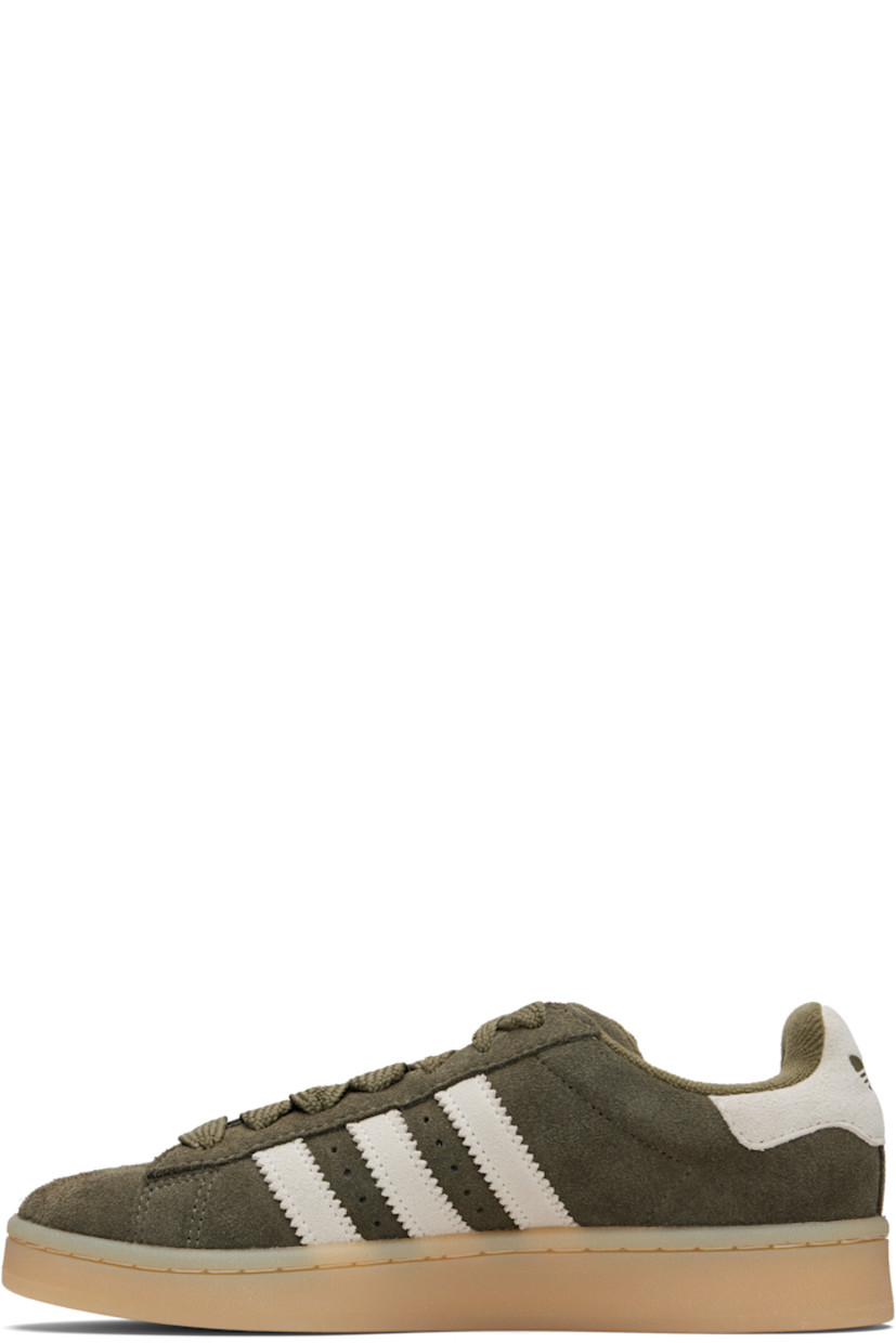 Low-top suede sneakers.

· Lace-up closure
· Logo embossed at tongue
· Padded tongue and collar
· Perforations at sides
· Signature serrated stripes
· Text stamp at outer side
· Logo embossed at heel tab
· Terrycloth lining
· Treaded rubber sole

Supplier color: Medium dark khaki/Off white/Gum