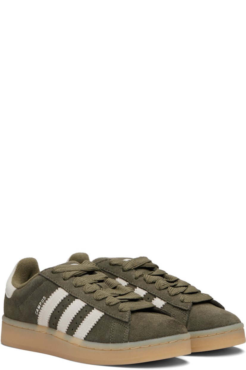 Low-top suede sneakers.

· Lace-up closure
· Logo embossed at tongue
· Padded tongue and collar
· Perforations at sides
· Signature serrated stripes
· Text stamp at outer side
· Logo embossed at heel tab
· Terrycloth lining
· Treaded rubber sole

Supplier color: Medium dark khaki/Off white/Gum