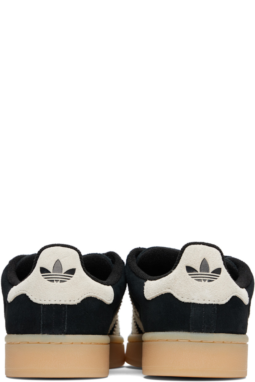Low-top suede sneakers.

· Lace-up closure
· Padded tongue and collar
· Logo printed at tongue and heel tab
· Text printed at outer side
· Perforations and signature serrated stripes at sides
· Terrycloth and mesh lining
· Treaded rubber sole

Supplier color: Core black/Cream white/Gum