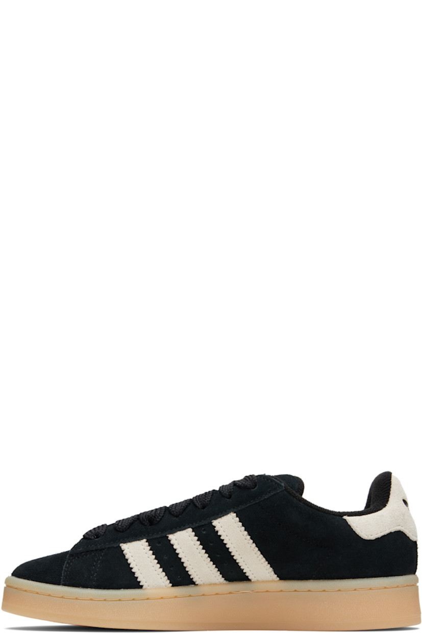 Low-top suede sneakers.

· Lace-up closure
· Padded tongue and collar
· Logo printed at tongue and heel tab
· Text printed at outer side
· Perforations and signature serrated stripes at sides
· Terrycloth and mesh lining
· Treaded rubber sole

Supplier color: Core black/Cream white/Gum